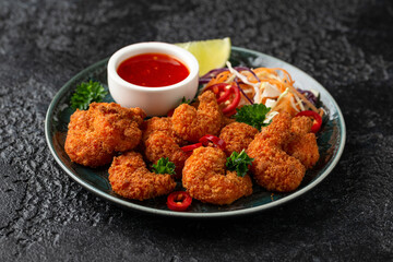 Crispy Prawns in breadcrumbs. Served with cabbage, carrot salad and soy and sweet chilli sauce