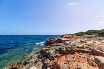 Very gently sloping low coast of Ibiza island and transparent turquoise sea, Balearic Islands, Spain