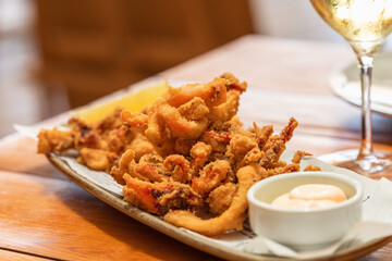 Mixed fried seafood with shrimp, squid and baby octopus and sauce mayonnaise (fritto misto di...