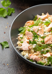 Salmon Couscous salad with feta cheese dressing and herbs. healthy food.