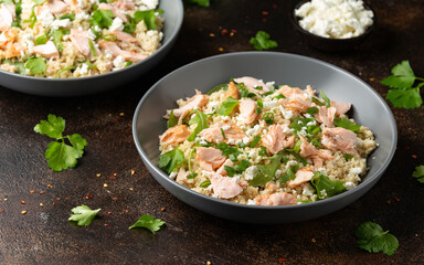 Salmon Couscous salad with feta cheese dressing and herbs. healthy food.