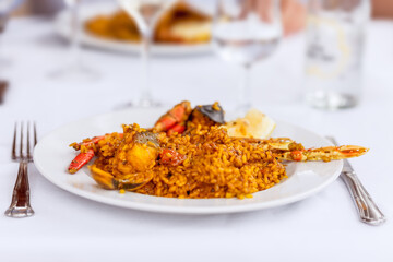 Dish with traditional spanish seafood paella with mussels, langoustine and fish (selective focus)