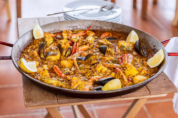 Traditional spanish seafood paella in traditional pan with mussels, langoustines and fish