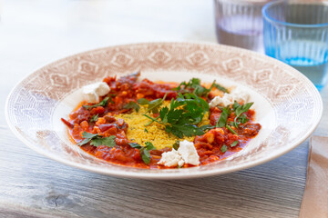 Vegetarian dish. Couscous with tomato stew (ragout) with tofu and parsley
