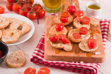 Friselle with cherry tomatoes and olive oil.