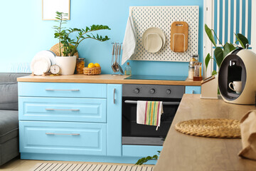 Stylish interior of modern kitchen with blue furniture