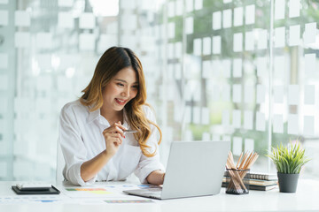 Portrait of smiling beautiful business asian woman working in office use computer with copy space. Business owner people sme freelance online marketing e-commerce telemarketing, work from home concept