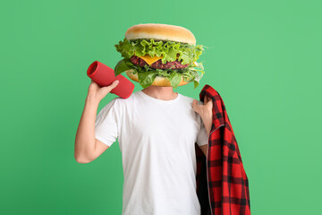 Man with tasty burger instead of his head on green background