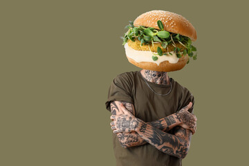 Tattooed man with tasty burger instead of his head on color background