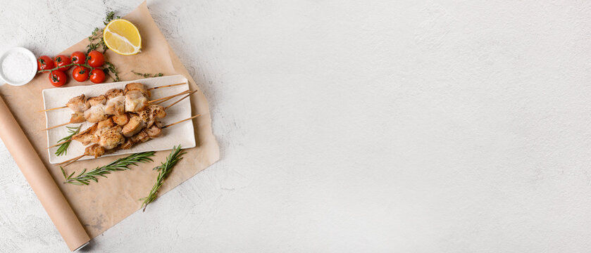 Composition with tasty grilled chicken skewers on light background with space for text