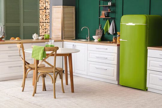 Interior Of Modern Kitchen With Dining Table And Green Vintage Refrigerator