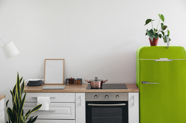 Interior of modern kitchen with stylish green vintage refrigerator