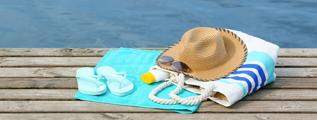 Set of beach accessories on wooden pier