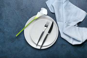 Beautiful table setting with white calla lily on dark color background