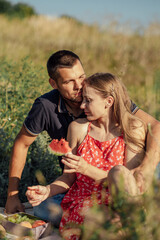 Romantic Picnic Date Ideas. Young couple in love on summer picnic with watermelon.