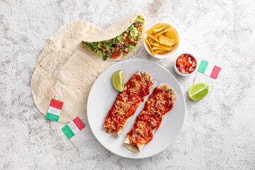 Composition with Mexican traditional food and flags on light background