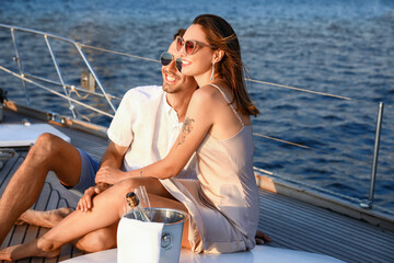 Happy young couple resting on yacht