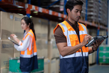 Warehouse worker and manager checks stock and inventory with digital tablet computer in the retail warehouse full of shelves with goods. Working in logistics, Distribution center.