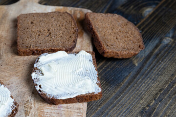 slices of black sliced bread with butter spread from milk