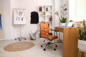 Interior of modern studio with workplace of clothes stylist