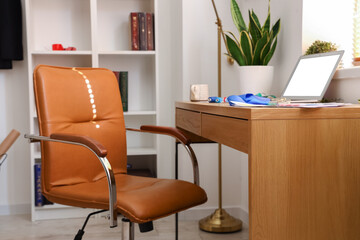 Workplace of clothes stylist in modern studio