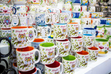 Multicolored owl mugs on the shelter - 508989747