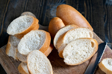 wheat baguette cut into pieces on a cutting board