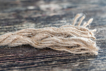 coarse linen fiber rope on a wooden board