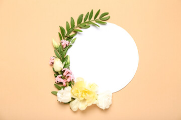 Blank card and beautiful flowers on beige background