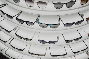 Rows of sunglasses on the counter of an optical store