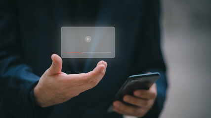 Hands of a man using a smartphone to stream online watch video on the internet Your tutorials to stream online. Watch videos on the Internet, live shows, shows, or tutorials.