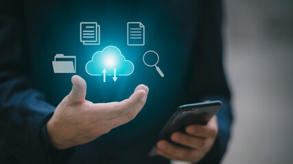 A man uses a smartphone to access an online document database. and automated processes to store files and documents in the organization effectively with enterprise business ERP technology