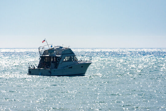 A fishing charter boat heads out onto Lake Michigan on a chilly summer's morning near Port Washington, Wisconson.