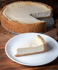 Cheesecake slice. Classical New York cheese cake on wooden background