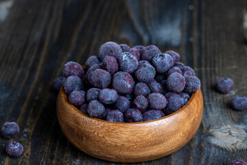 frozen blueberries on a wooden table