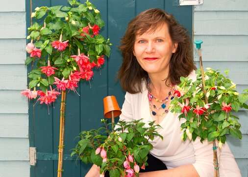 Portrait of a woman with Standard Fuchsia flowers.