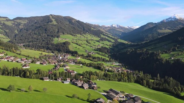 Aerial shot of the village Alpbach surrounded by scenic mountain landscape, traveling in Tyrol, Austria.