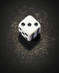 dice with the number three on a black background - 508999909