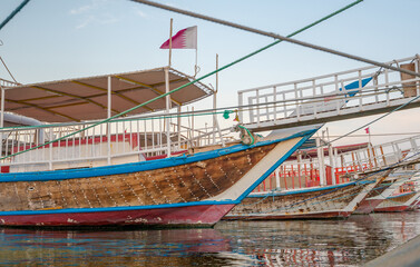 Traditional dhows parked together in Doha Corniche.