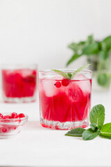 Cranberry drink with ice and mint.
