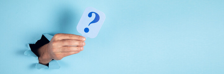 man holding card of question mark on blue background