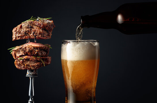 Beer and grilled beef steak.