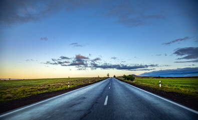 asphalt road under abstract sky