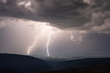 Naklejka na ściany i meble Lightning strikes during a summer thunderstorm in the northern Black Forest in the district of Rastatt