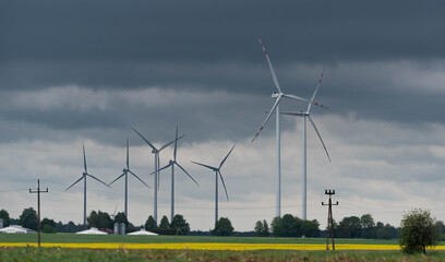 Wind farm in Poland. Windmills in arable fields. Renewable energy sources in Poland. Power plant wind turbines.