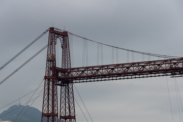 bizkaia suspension bridge with metal structure considered world heritage for transport with cloudy sky crossing the river in spring day