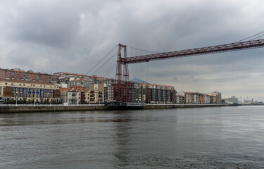 bizkaia suspension bridge with metal structure considered world heritage for transport with cloudy sky crossing the river in spring day