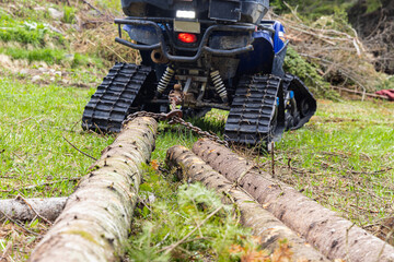 Ground level perspective on the rear of an all terrain vehicle, ATV, with chain wrapped around...