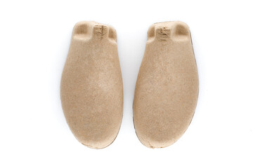 Pair of shoe tree made from recycled cardboard paper isolated on white background, device that used for placed inside a shoe to preserve its shape.
