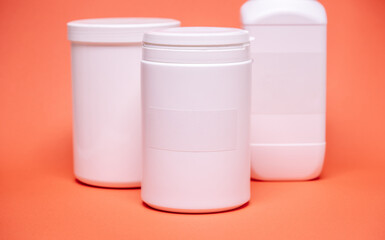 White plastic jar on a color  background with empty label for text for food or dietary supplements
